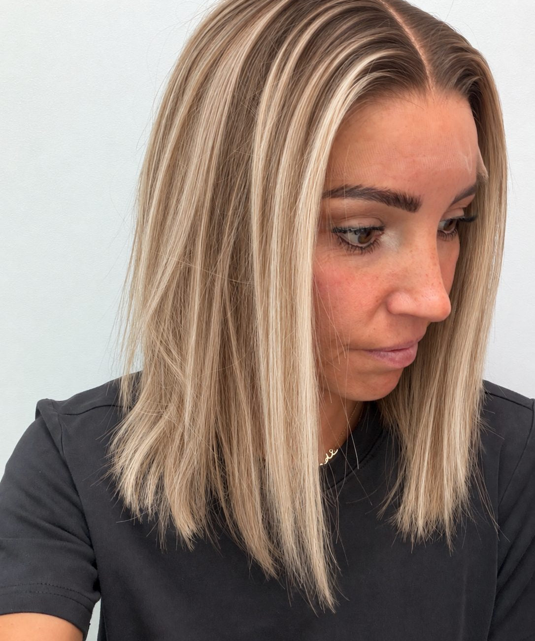 Champagne Melt 14-inch blunt bob wig in rooted champagne blonde balayage, side view showing the hairline