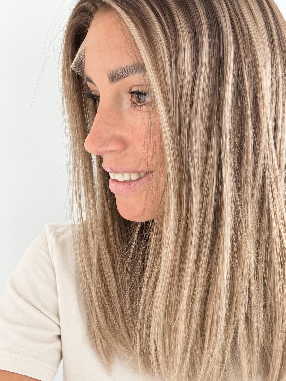 Champagne Melt 16-inch layered straight wig in rooted champagne blonde balayage, side view showing the hairline