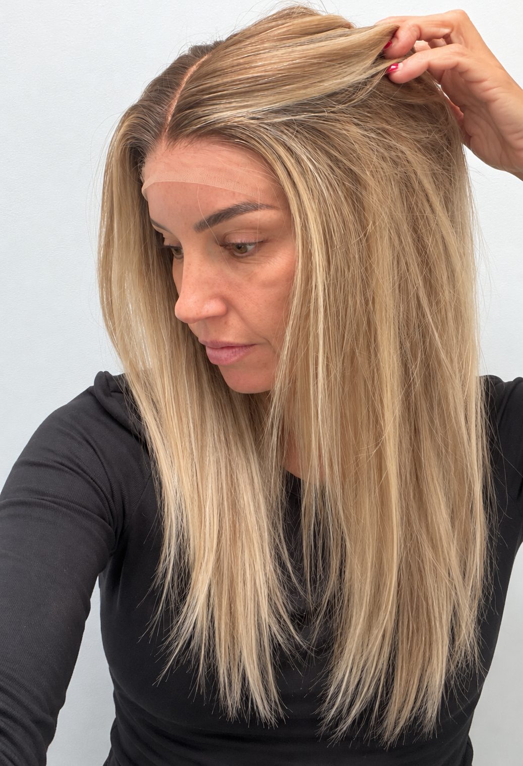 Champagne Melt 22-inch straight wig in rooted champagne blonde balayage, side view showing the hairline