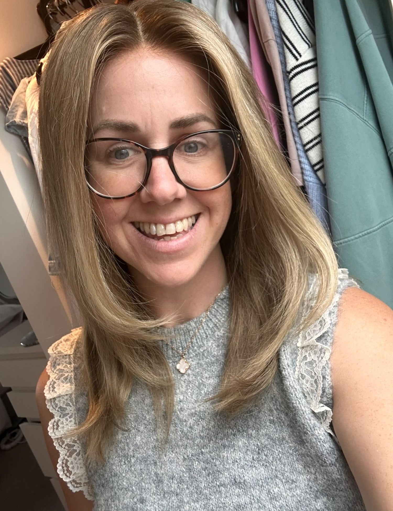 Customer in glasses wearing a dark blonde layered wig