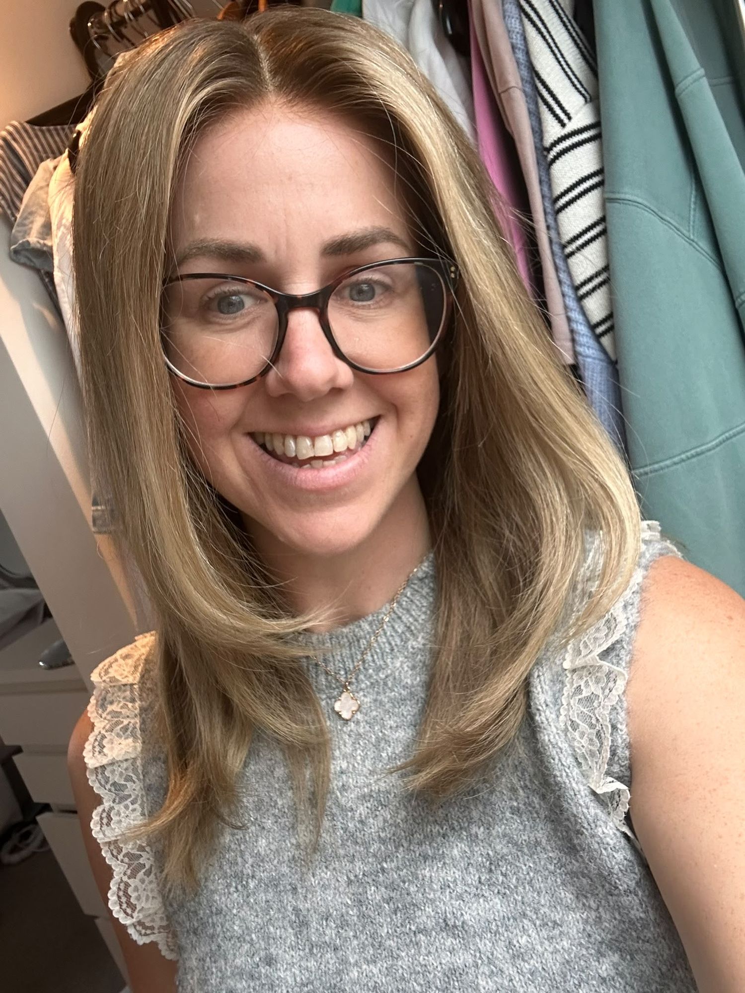 Customer in glasses wearing a dark blonde layered wig