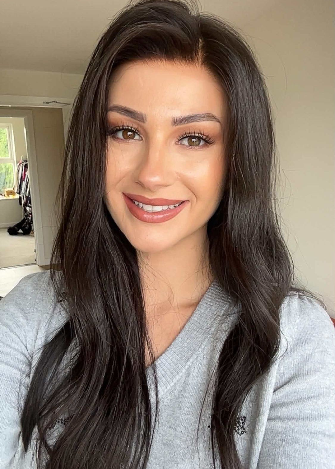 Customer wearing a long dark brunette layered wig