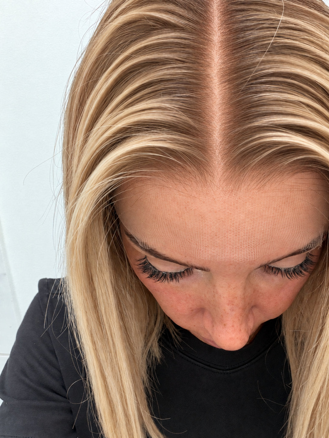 Close-up of the natural lace hairline and parting on a Golden Honey human hair wig in golden honey blonde balayage