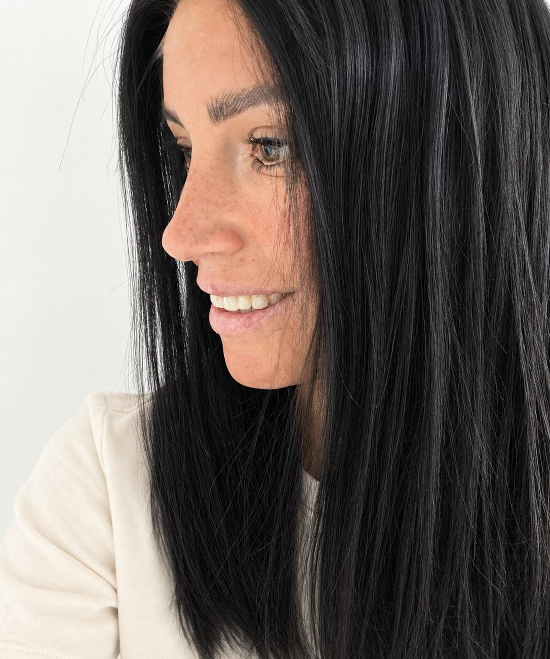 Midnight 16-inch layered straight wig in jet black, side view showing the hairline