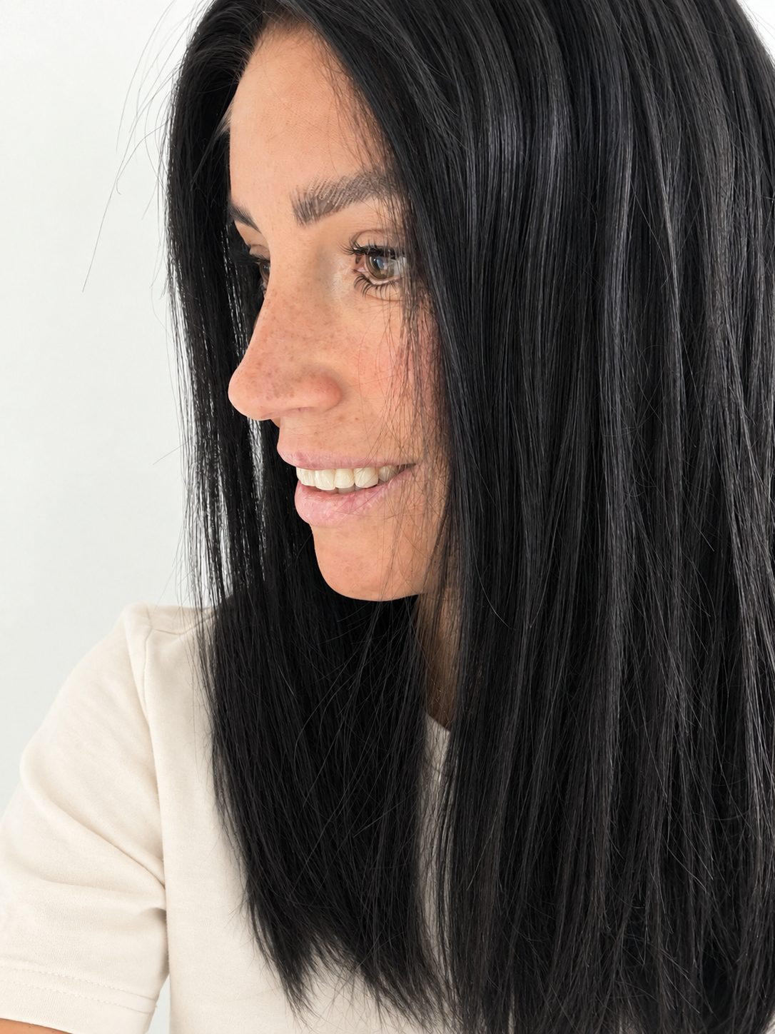 Midnight 16-inch layered straight wig in jet black, side view showing the hairline