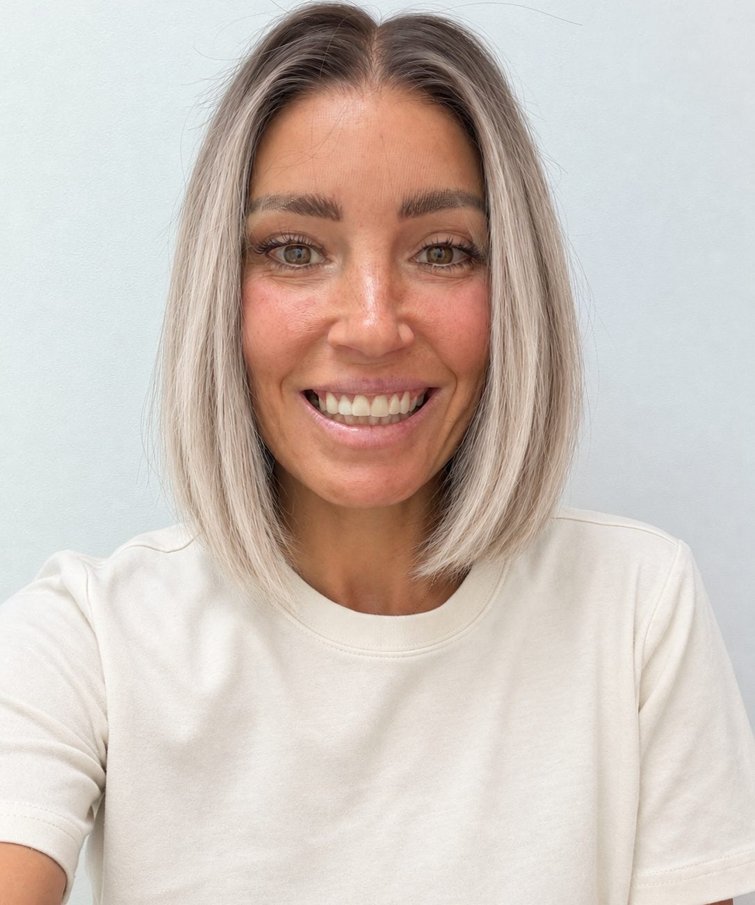 Nordic Pearl 10-inch blunt bob wig in rooted platinum blonde, front view
