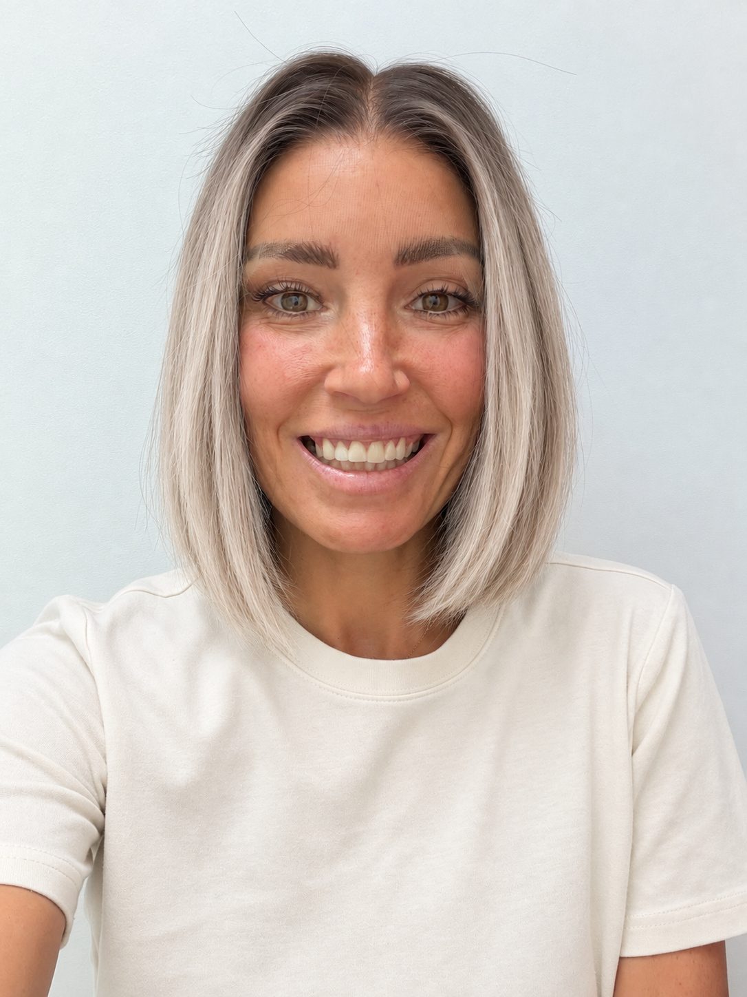 Nordic Pearl 10-inch blunt bob wig in rooted platinum blonde, front view