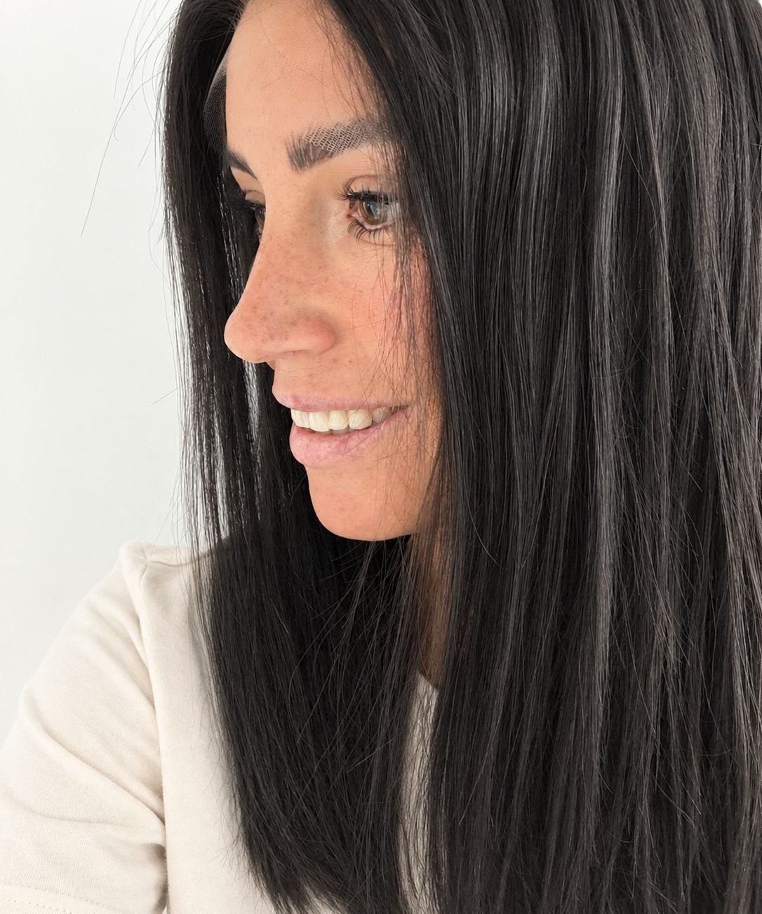 Soft Onyx 16-inch layered straight wig in soft natural black, side view showing the hairline