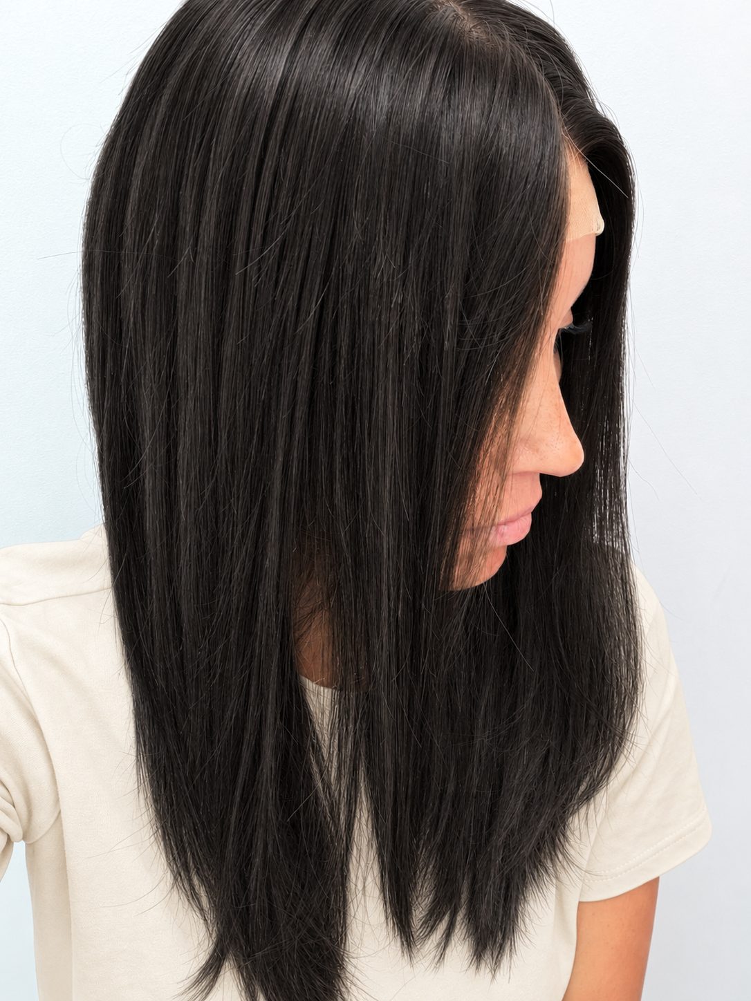 Soft Onyx 18-inch layered straight wig in soft natural black, side view showing the hairline