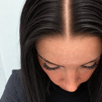 Close-up of the natural lace hairline and parting on a Soft Onyx human hair wig in soft natural black