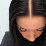 Close-up of the natural lace hairline and parting on a Soft Onyx human hair wig in soft natural black