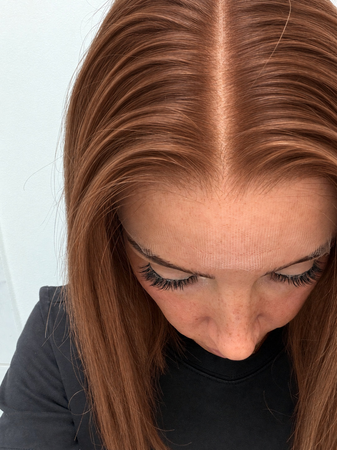 Close-up of the natural lace hairline and parting on a Spiced Auburn human hair wig in warm spiced auburn
