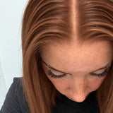 Close-up of the natural lace hairline and parting on a Spiced Auburn human hair wig in warm spiced auburn