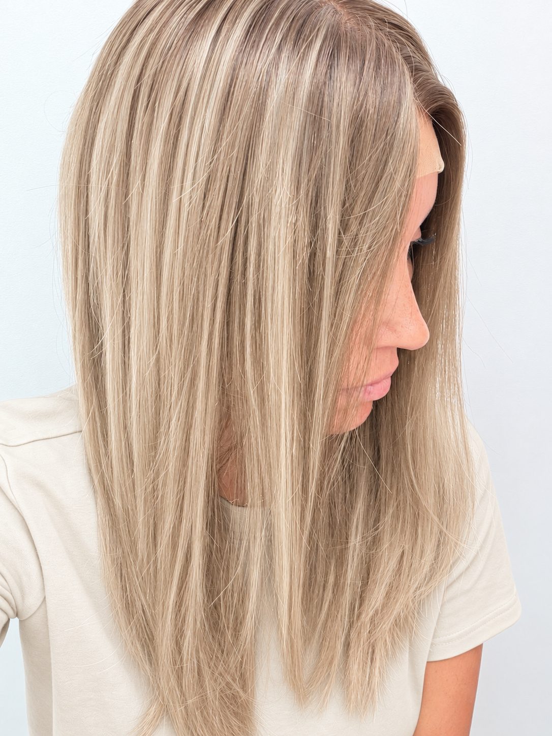 Vanilla Sand 18-inch layered straight wig in rooted beige blonde, side view showing the hairline